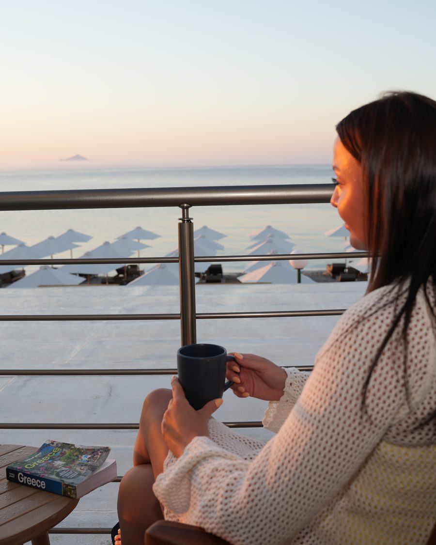 Guest with a morning coffee on a sea-view balcony at Starlight, Kardamena