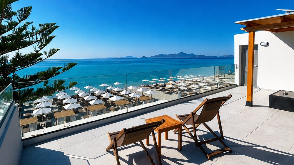 Sea-view terrace at Starlight, looking over the beach umbrellas to the Aegean Sea in Kardamena, Kos
